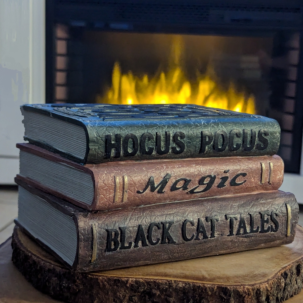 Decorative Book Stack with Black, Brown, and Green Accents